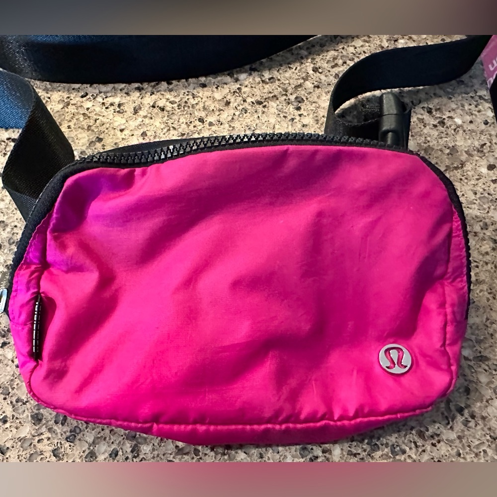 Hot pink and black Lululemon everyday belt bag. Smaller (original) size